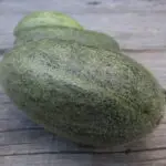 Badem acur melon photographed on an old wooden cabinet.