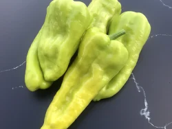 Five Kale hot peppers on granite surface