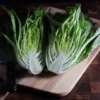Halved Devil's Ear romaine lettuce on cutting board