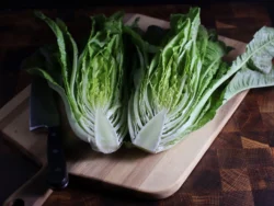 Halved Devil's Ear romaine lettuce on cutting board