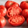 Fresh red Ege Pembesi tomatoes, one sliced open.