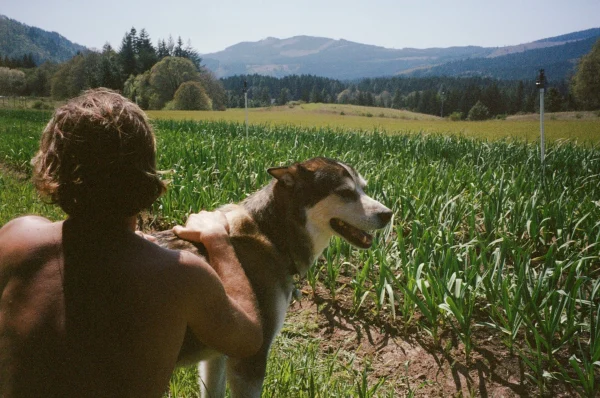 Garlic, farmer Sasha Moghadam and Mooshi the dog pictured on the Husum, WA, farm