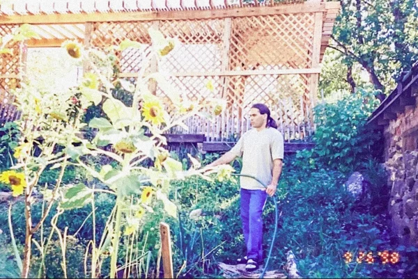 Jamshid Moghadam watering his home garden in Colorado
